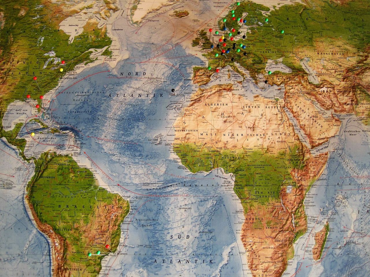 World map with pins marking travel destinations for eSIM price comparison