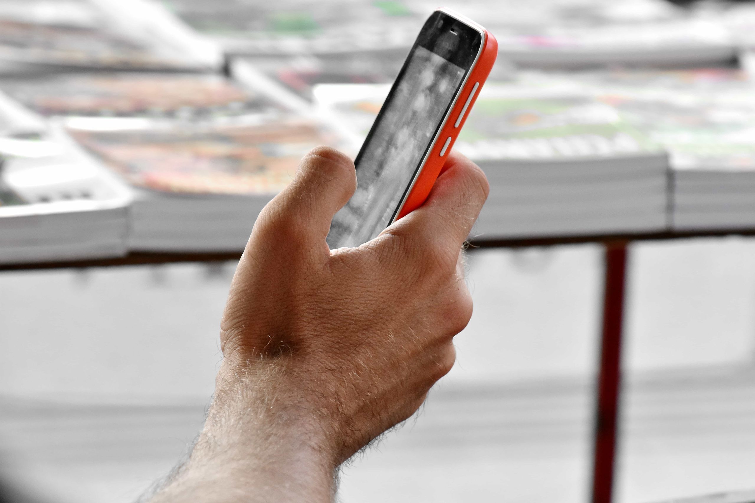Close-up of a hand holding a smartphone showing mobile data in use
