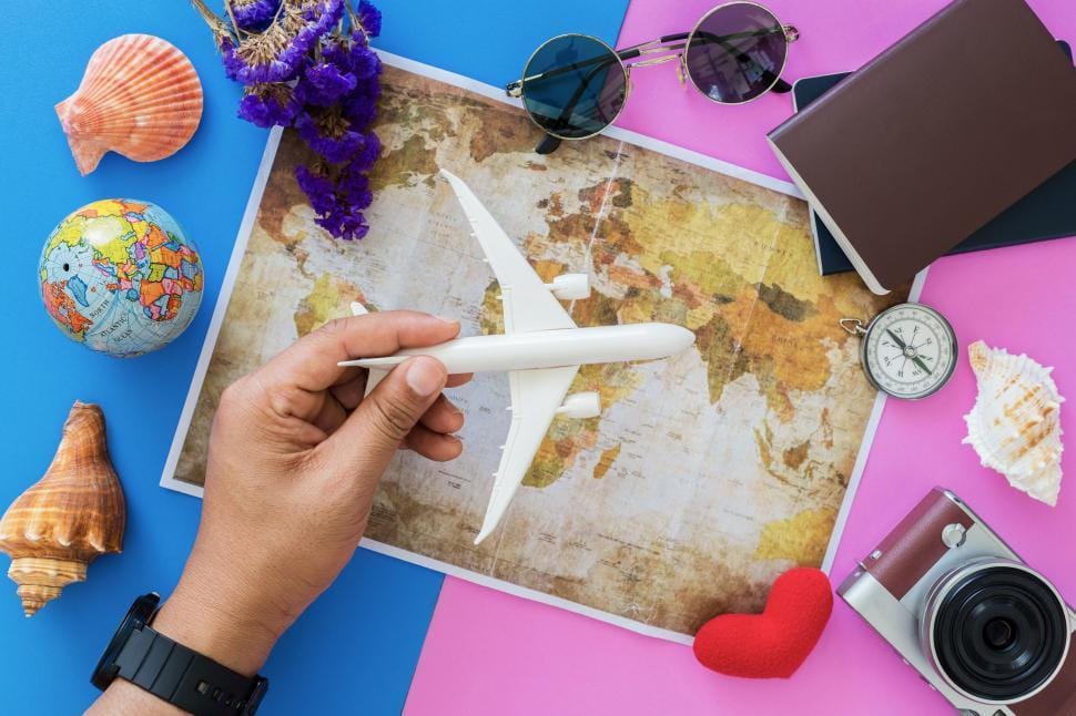Travel essentials flat lay including phone, passport and boarding pass